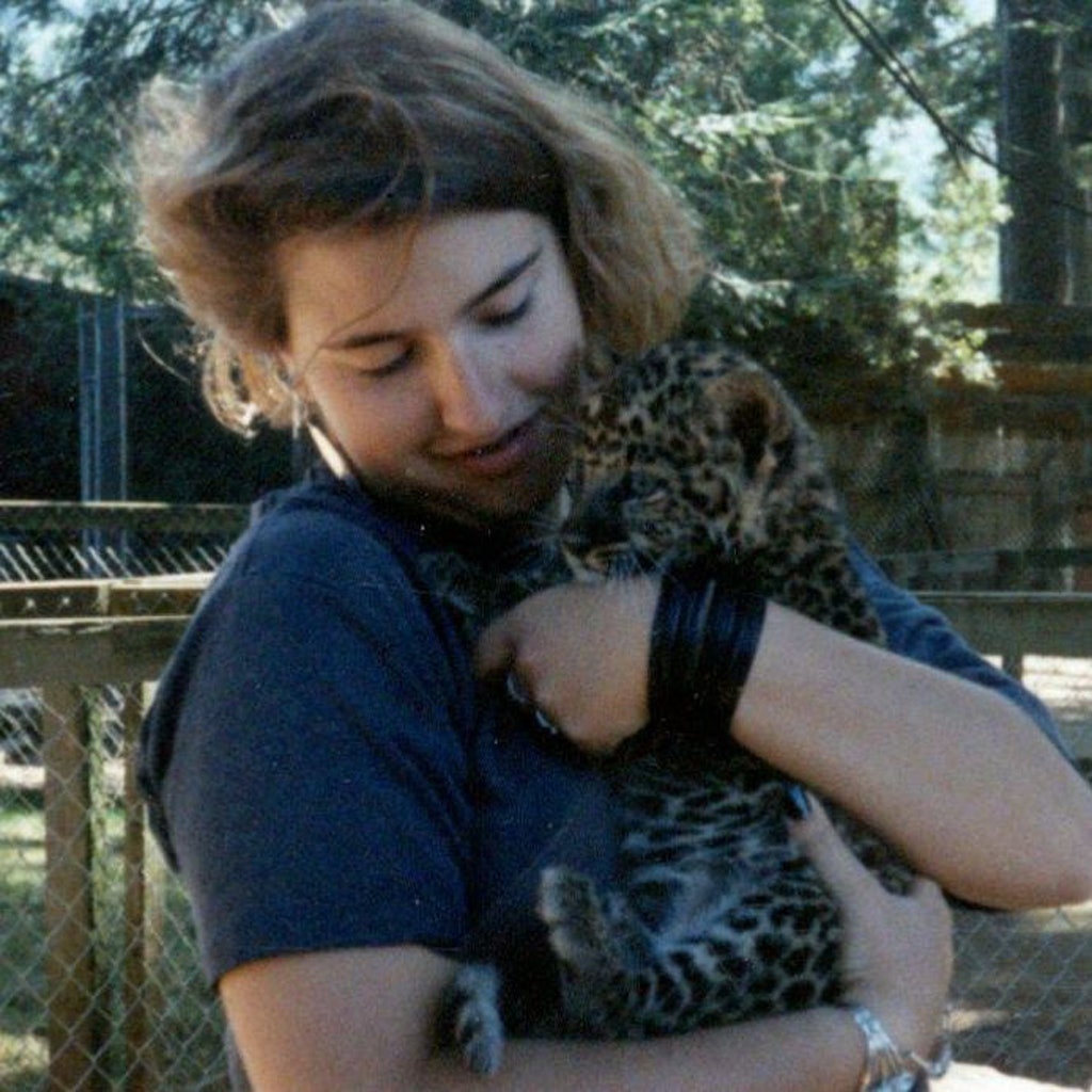 Christi at age 13 holding a baby leopard